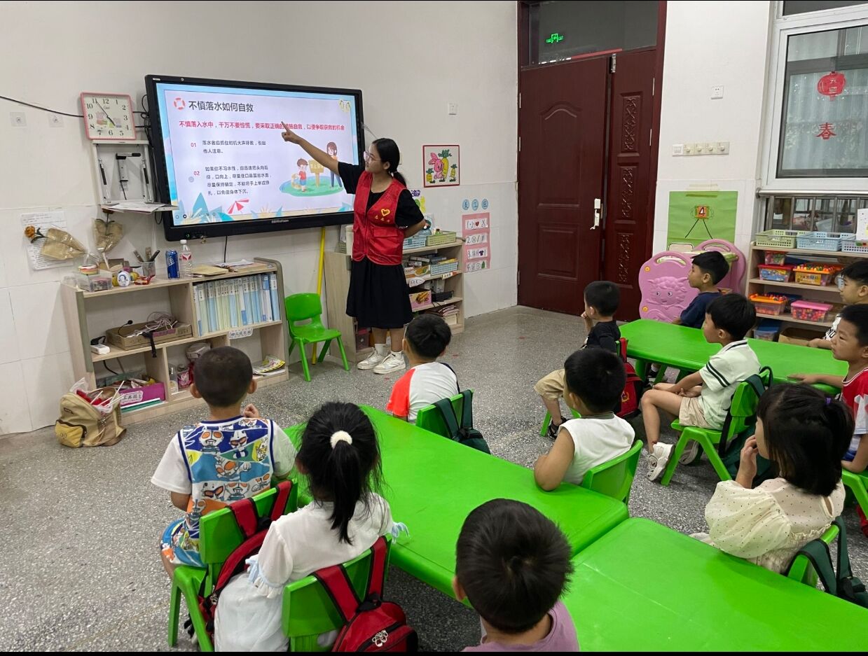 圖為實(shí)踐隊(duì)員為小朋友講解不慎落水如何自救